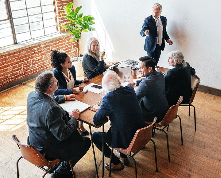 People sit around a conference table having a meeting