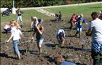 Students working as a tem, bettering their community and school, while learning the value of LID and having a blast in the mud! [Click here to view full size picture]